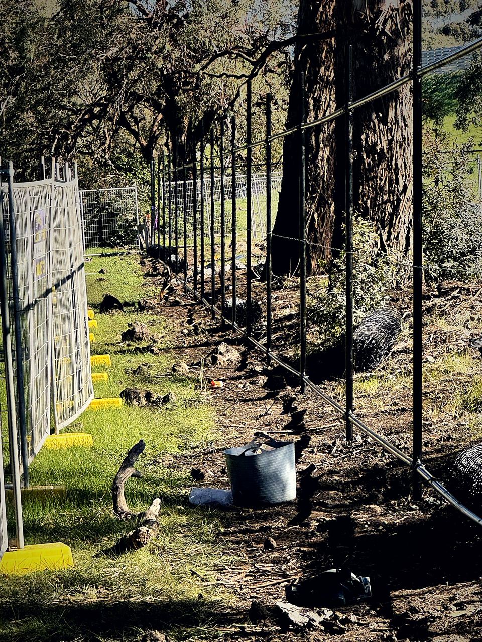 Black chain mesh fence being installed